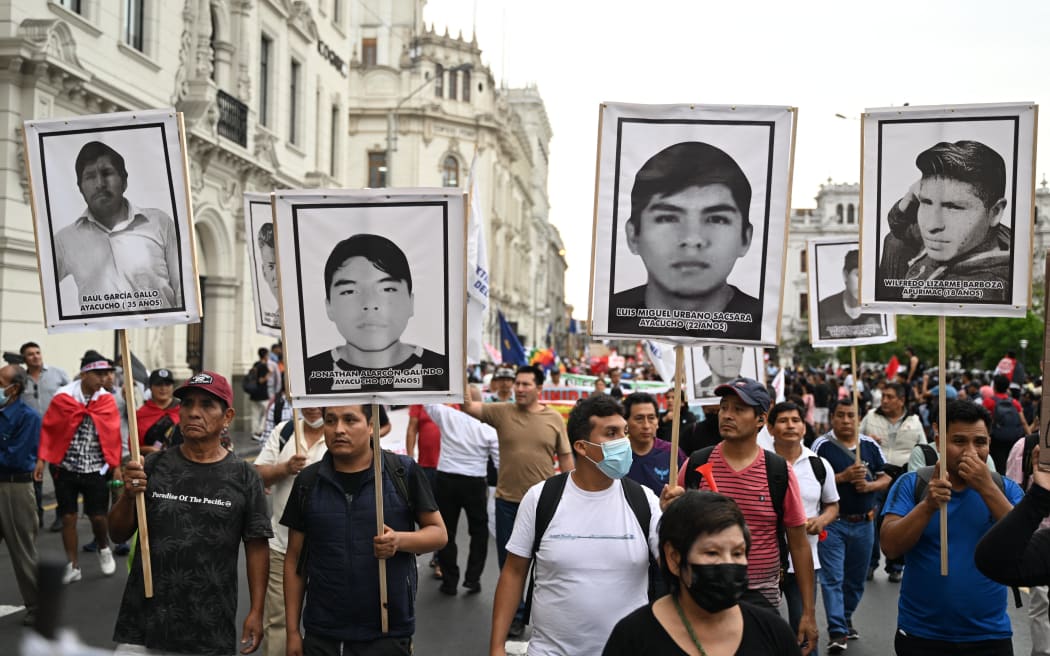 Protestors hold banners with portraits of victims of past protests during a demonstration against the government of Peruvian President Dina Boluarte in Lima on January 4, 2023. - Political upheaval has roiled Peru in the last weeks. Then-president Pedro Castillo on December 7 sought to dissolve Congress and rule by decree, only to be ousted and thrown in jail. Castillo was replaced by his vice president, Dina Boluarte. But Boluarte has faced a wave of often violent demonstrations calling for Castillo to be returned to power. (Photo by ERNESTO BENAVIDES / AFP)
