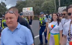 Christopher Luxon and Nicola Willis are confronted by protesters at the Big Gay Out 16 February 2024.