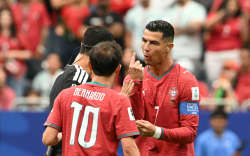 Portugal’s forward Cristiano Ronaldo (R) speaks with the referee, FIFA World Cup, 2026.