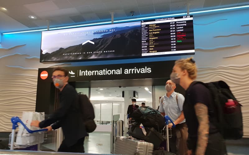 Travellers with face masks at Auckland Airport international arrivals during the Covid-19 coronavirus outbreak on 20/3/2020.