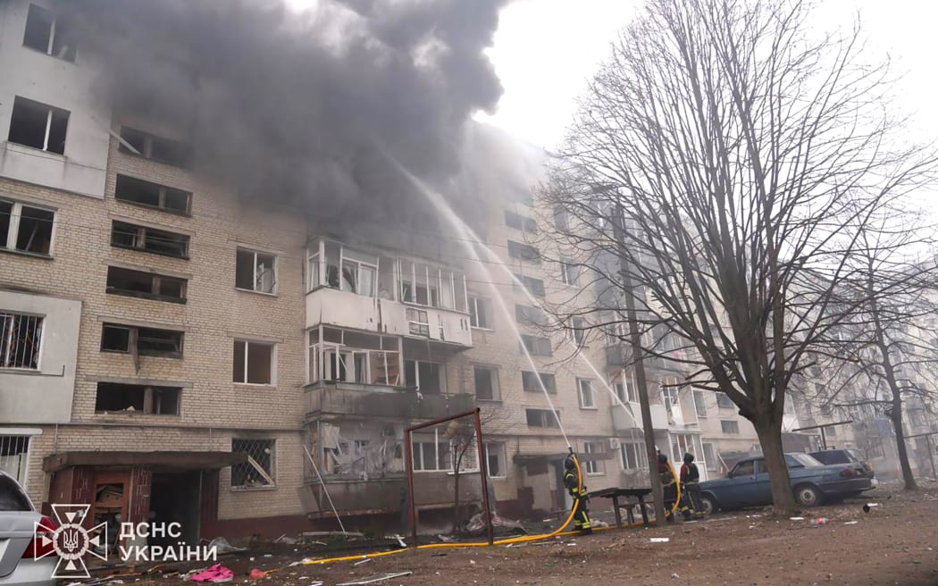 This handout photograph taken and released by the Ukrainian Emergency Service on March 24, 2025, shows Ukrainian rescuers working to extinguish a fire in a residential building following a missile attack in Sumy, northeastern Ukraine, amid the Russian invasion of Ukraine. A Russian missile attack on Ukraine's northeastern city of Sumy on March 24, 2025, wounded 65 people, the regional prosecutor's office said, as Moscow and Washington held talks in Saudi Arabia on a potential ceasefire. (Photo by Handout / UKRAINIAN EMERGENCY SERVICE / AFP) / RESTRICTED TO EDITORIAL USE - MANDATORY CREDIT "AFP PHOTO / UKRAINIAN EMERGENCY SERVICE" - NO MARKETING NO ADVERTISING CAMPAIGNS - DISTRIBUTED AS A SERVICE TO CLIENTS