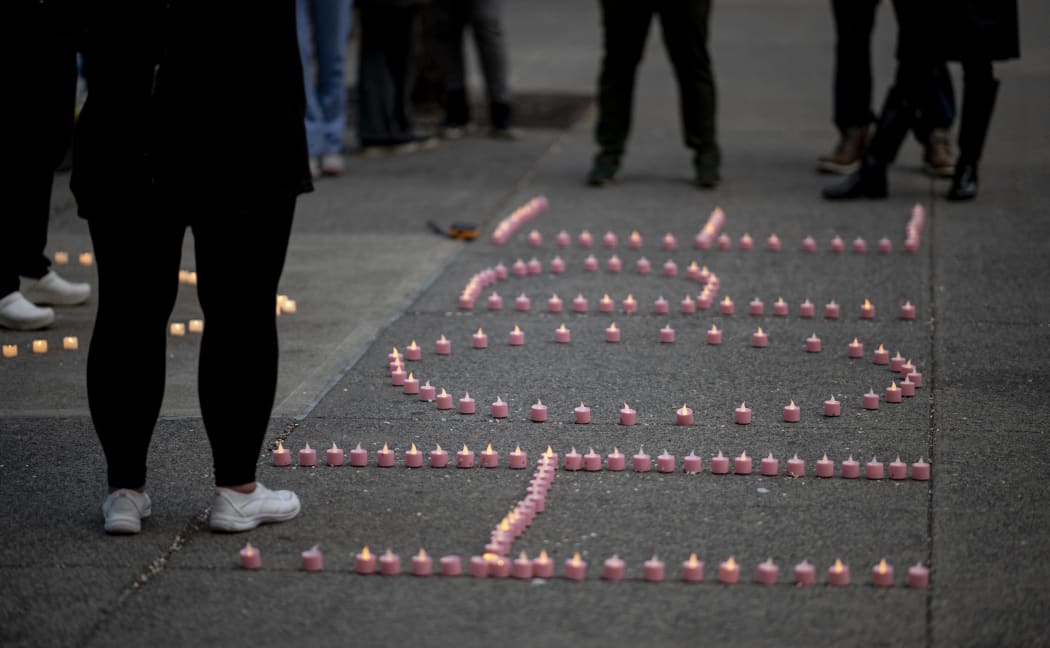Nurses and healthcare workers formed the word "Hope" with candles as they mourn and remember their colleagues who died during the outbreak of the novel coronavirus during a demonstration outside Mount Sinai Hospital in Manhattan on April 10, 2020 in New York City.
