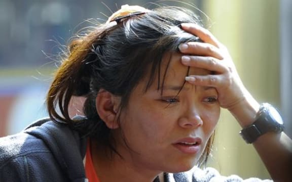 A relative of one of the Sherpas grieves as bodies arrive at a monastery after the avalanche.