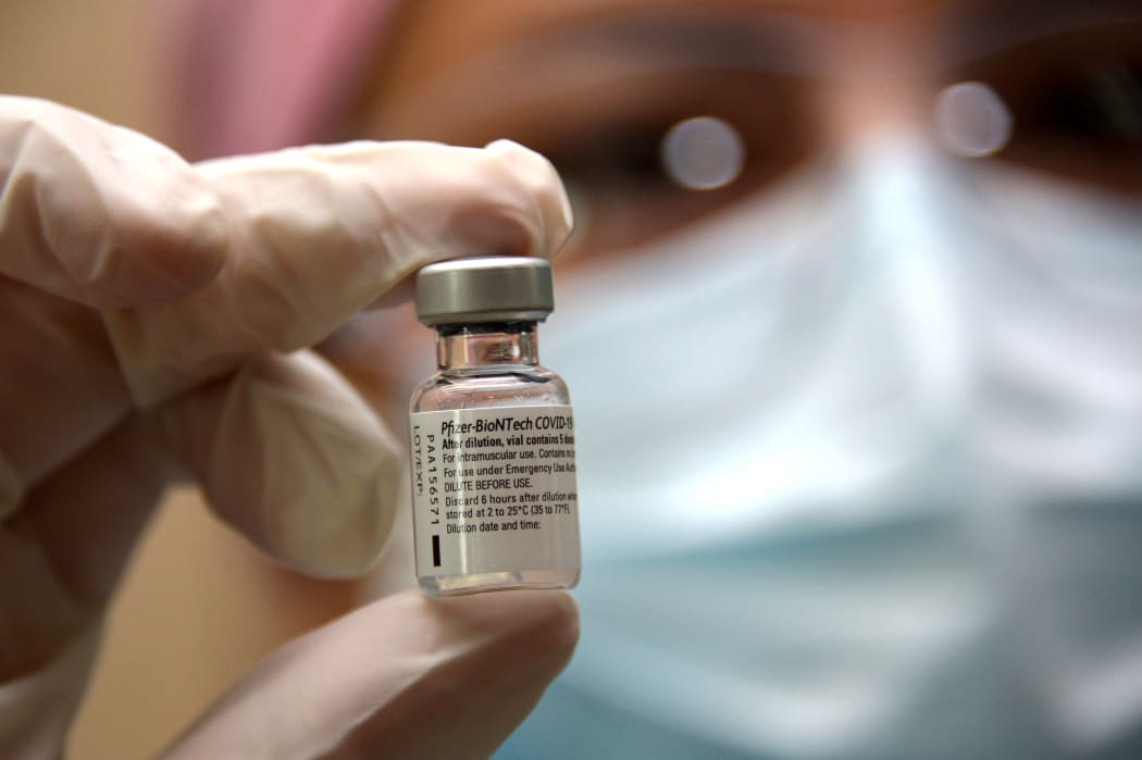 A nurse holds a vial of the Pfizer vaccine at the Pablo Arturo Suarez Hospital in Quito on January 21, 2021.
