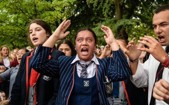 School students perform a haka during a vigil in Christchurch on March 18, 2019, three days after a shooting incident at two mosques in the city that claimed the lives of 50 Muslim worshippers. (Photo by ANTHONY WALLACE / AFP)
