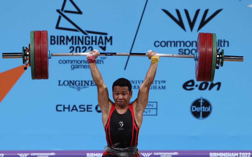 Papua New Guinea's Morea Baru competes in the men's 65kg weightlifting event on day two of the Commonwealth Games at the NEC Arena in Birmingham, central England, on July 30, 2022. (Photo by Darren Staples / AFP)