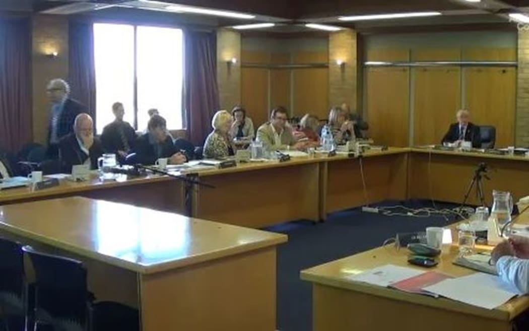 A screengrab from video of Auckland Council proceedings shows Len Brown (left) walking out.