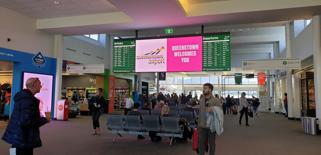 Travellers arrive at Queenstown Airport.