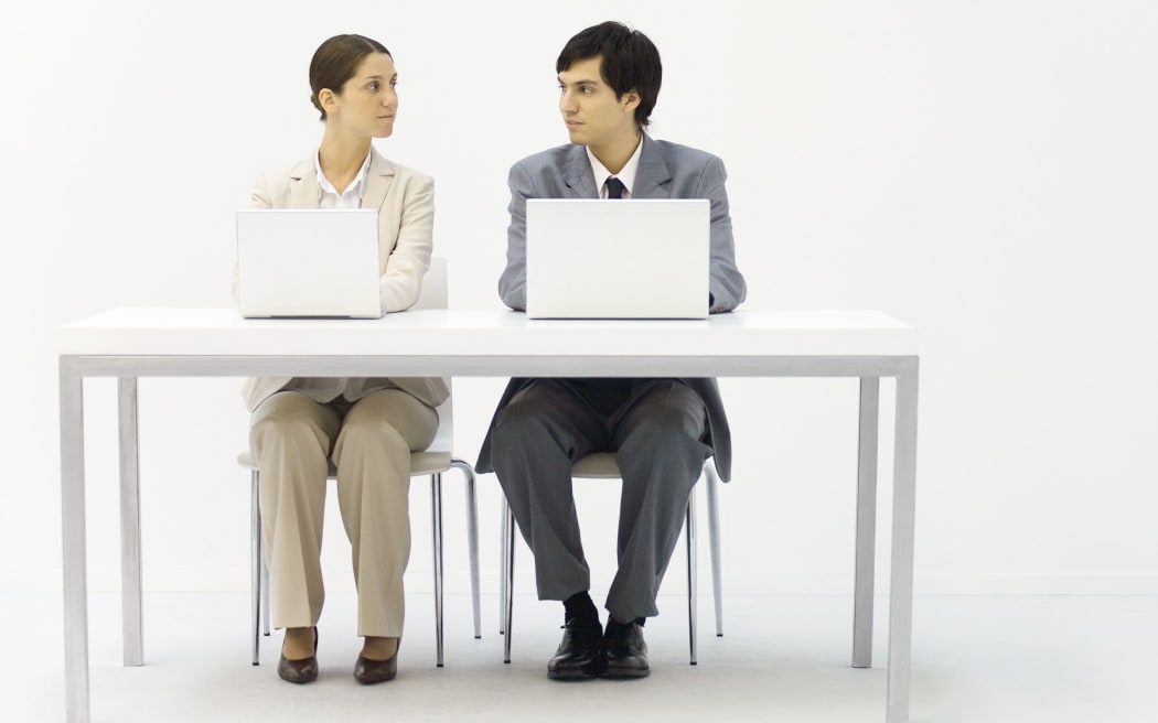 Office workers sitting by side.