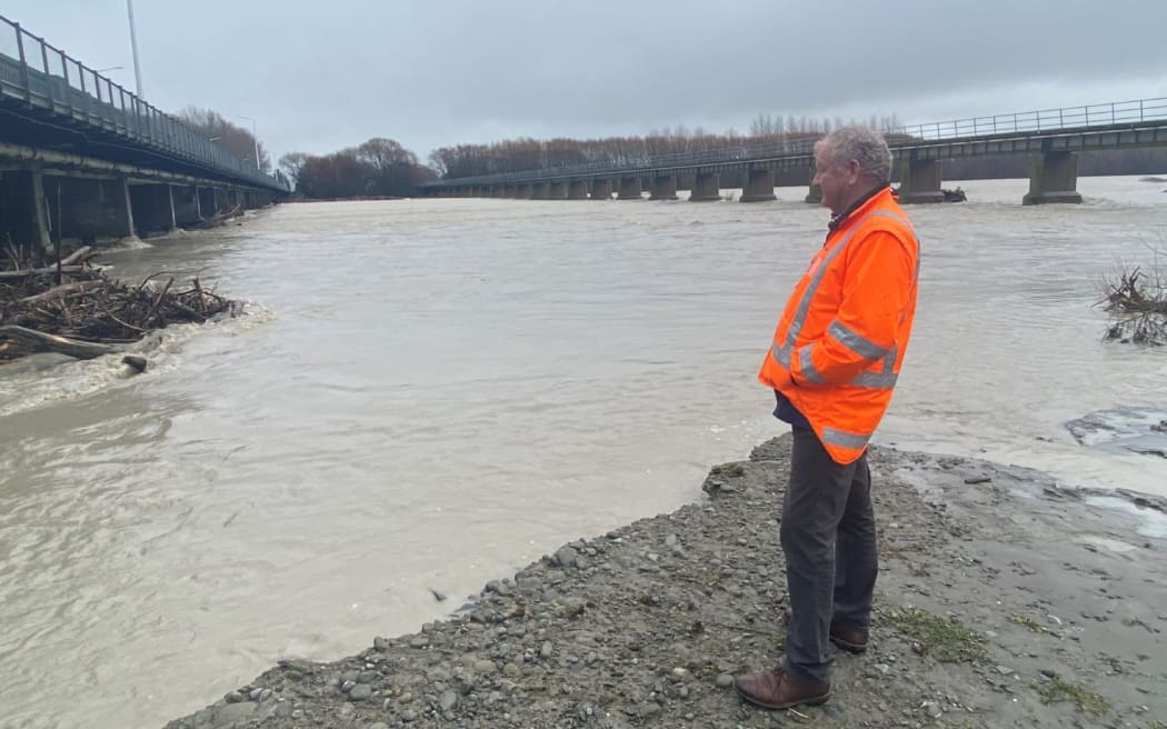 Ashburton Mayor Neil Brown surveying the debris buildup on 24 July.