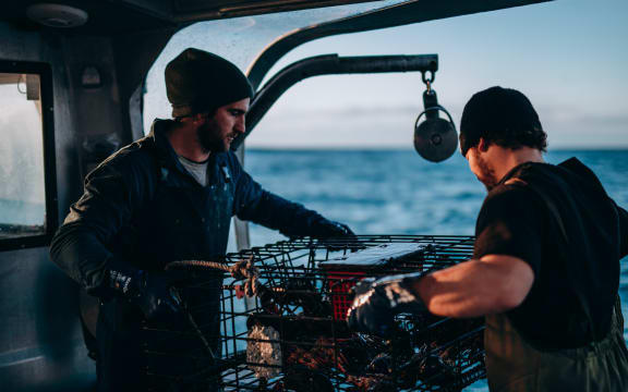 Two people working on a Tora Collective boat.