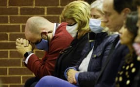 A man prays as people attend a mass in memory of Conservative British lawmaker David Amess, who was fatally stabbed, at Saint Peter's Catholic Parish of Eastwood in Leigh-on-Sea, a district of Southend-on-Sea, in southeast England on October 15, 2021.