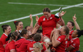 Canada's lock Sophie de Goede receives the player of the tournament trophy after the Women’s Rugby World Cup final between Canada and England at Twickenham, London, September 27, 2025. (Photo by Adrian Dennis / AFP)
