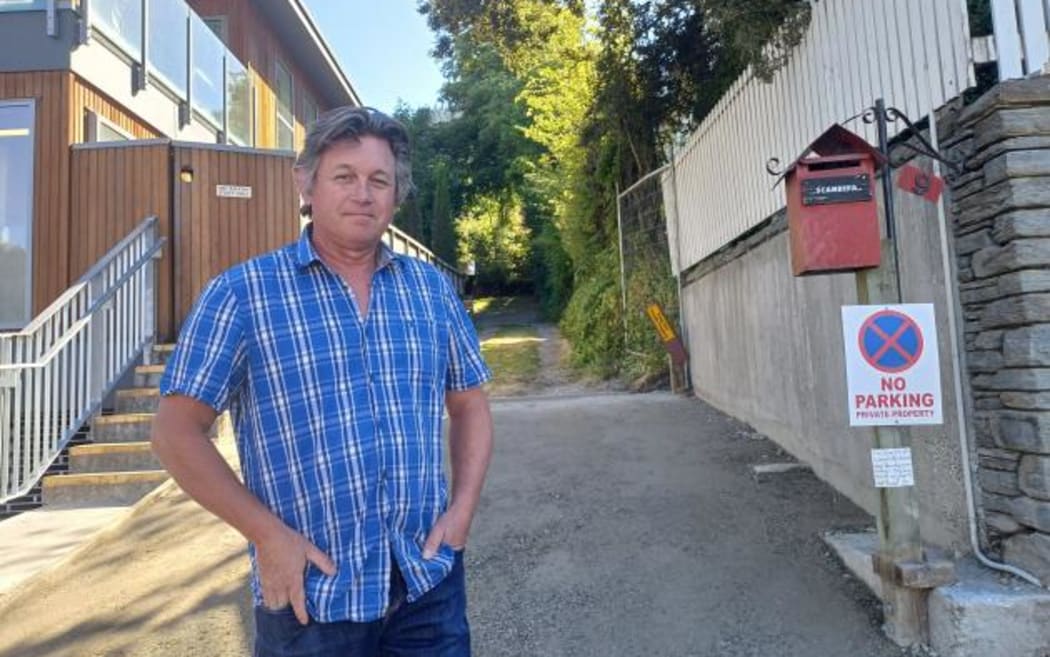 Henry Street property owner Nigel Sadlier in front of his driveway, which is being treated as a thoroughfare by pedestrians.
