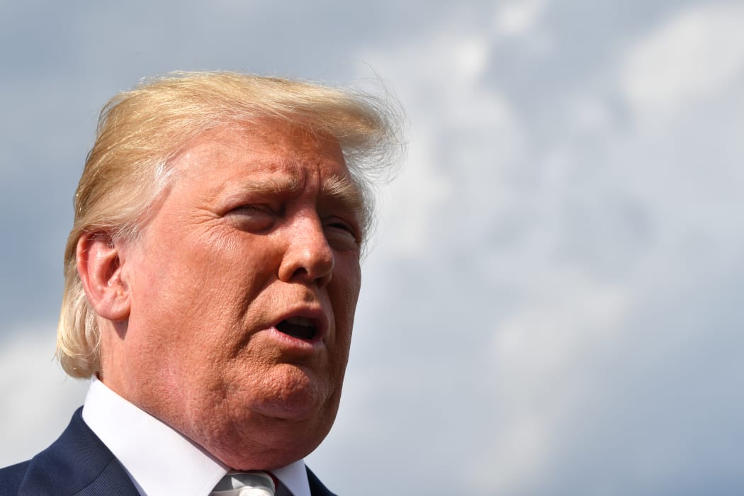 US President Donald Trump gives a statement about the recent mass shootings in El Paso and Dayton before boarding to Washington at Morristown Airport on August 04, 2019.