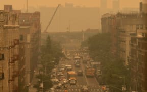 Smoky haze from wildfires in Canada blankets a neighbourhood on 7 June, 2023 in the Bronx borough of New York City.
