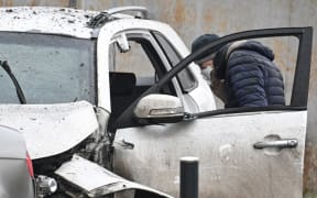 An investigator works at the car blast site in southern Moscow on December 22, 2025.