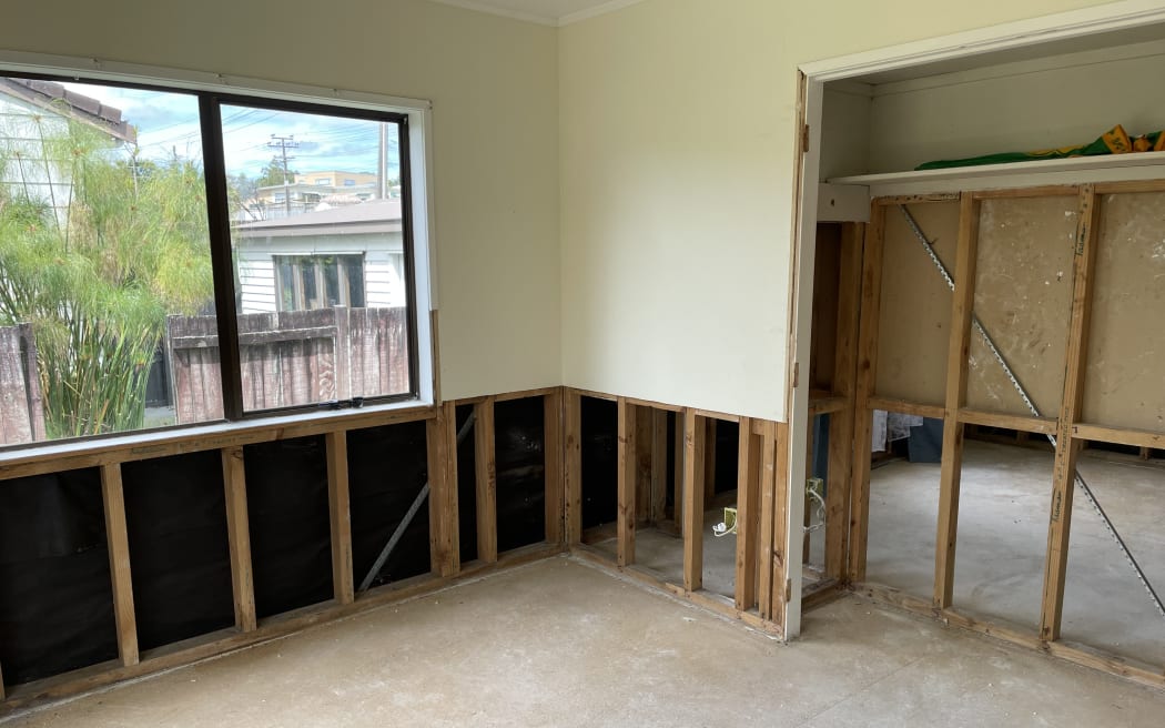 Inside Izma Azad's yellow-stickered West Auckland home, damaged by flooding in January.