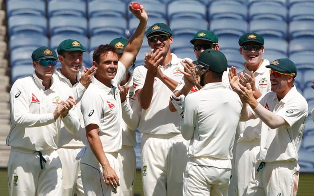 Australian spinner Steve O'Keefe celebrates taking a wicket with team-mates.