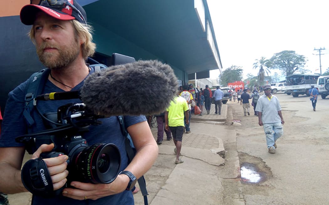 Filmmaker Paul Wolffram holding a camera