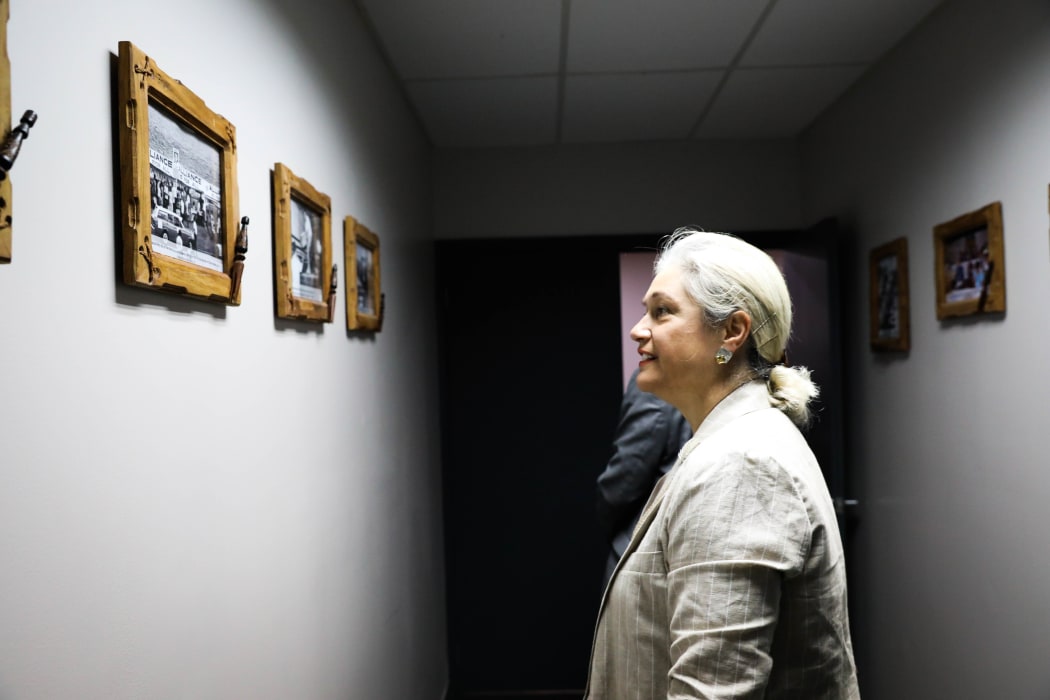 National MP Harete Hipango looks at photographs on the wall at the Fijian Elections Office