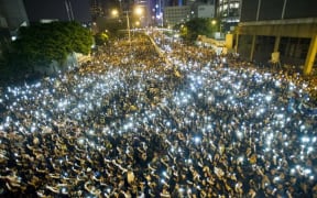Protesters hold up mobile phones in a display of solidarity - but communications are disrupted.