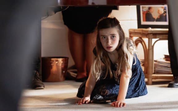 Scarlett under the piano at the wake