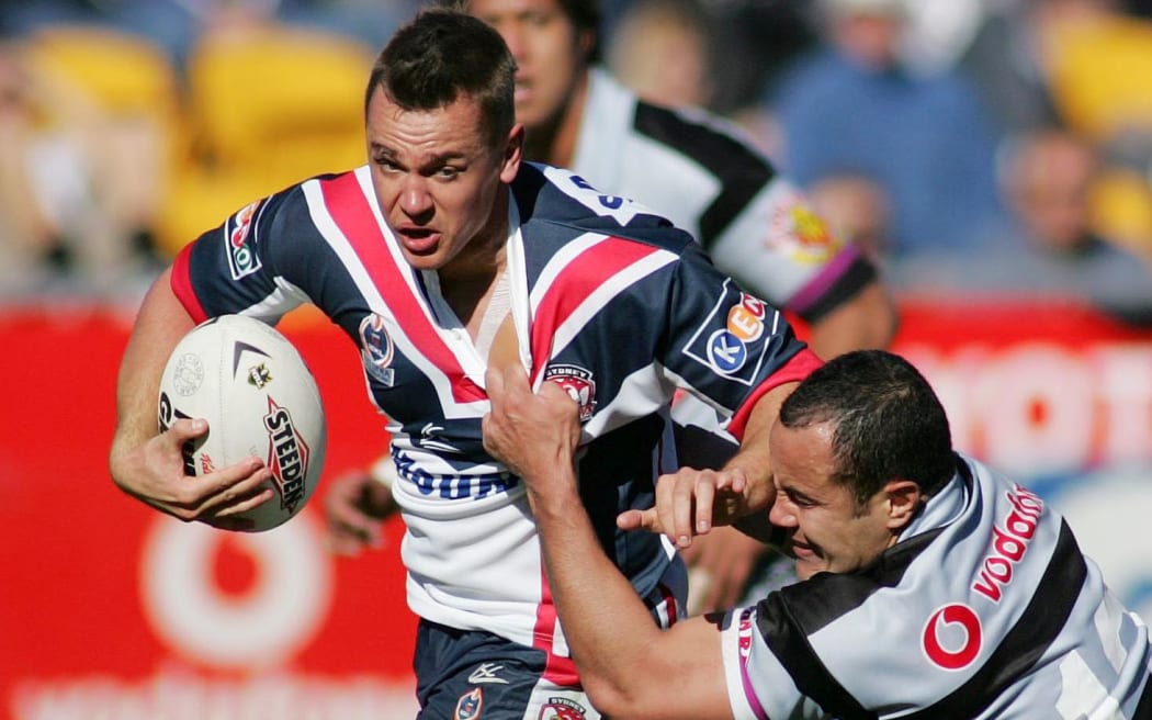 Chad Robinson is tackled by Warriors player Monty Beetham in a 2004 NRL match.