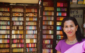 Shobha Narayan in front of a street store.