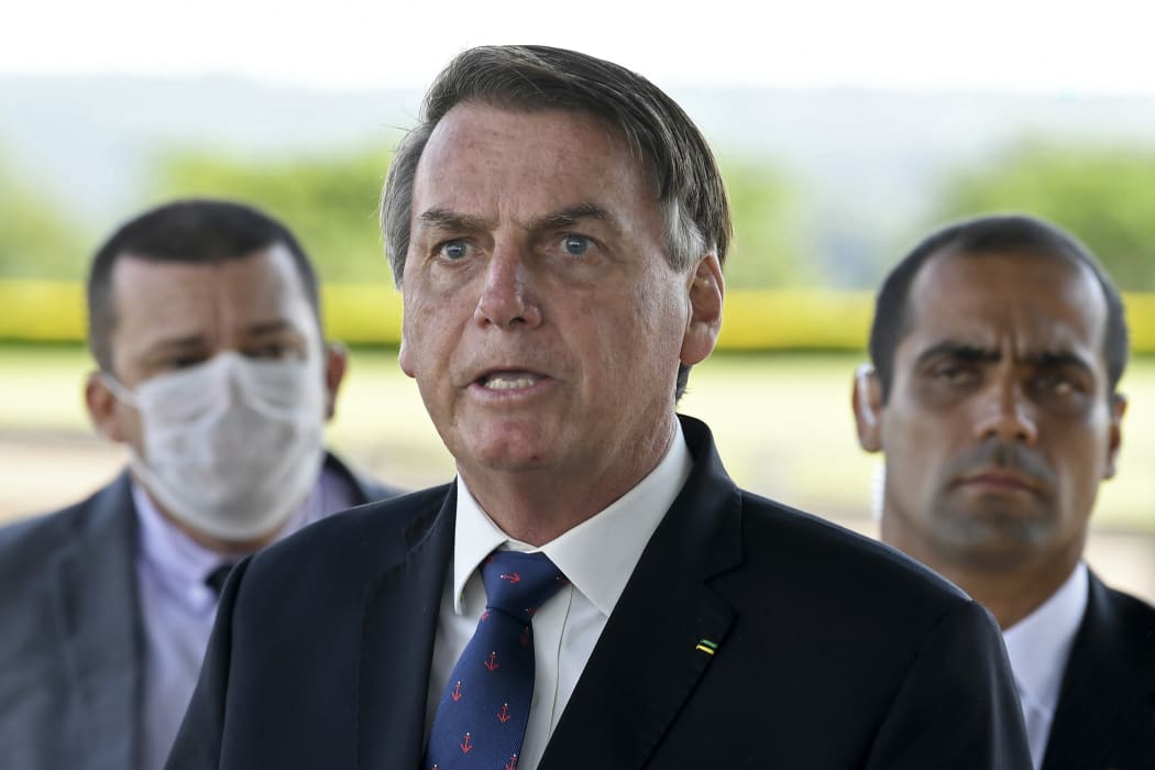 President Jair Bolsonaro (centre) maintains that Brazilians must keep working while taking precautions not to catch Covid-19.