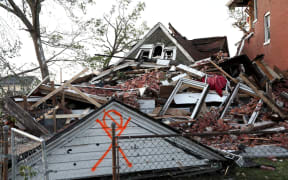A house lies collapsed under a mountain of bricks, after a tornado struck in St. Louis, on Friday.