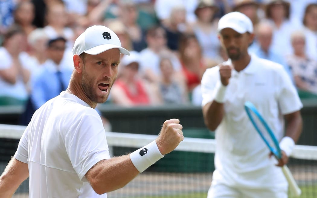 Michael Venus and Raven Klaasen celebrate winning a point.