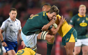 South Africas' Eben Etzebeth is tackled by Australia's Kurtley Beale during the 2019  Rugby Championship.