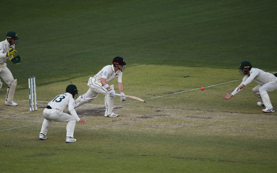Australia's Travis Head takes a catch to dismiss Henry Nicholls.