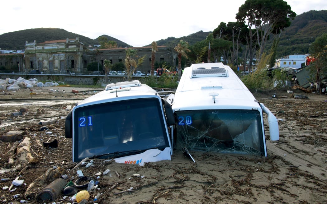Damaged tourist buses are seen at the port of Casamicciola, following heavy rains that caused a landslide on the island of Ischia, southern Italy. Italian rescuers were searching for a dozen missing people on the southern island of Ischia after a landslide killed at least one person, as the government scheduled an emergency meeting. A wave of mud and debris swept through the small town of Casamicciola Terme early Saturday morning, engulfing at least one house and sweeping cars down to the sea, local media and emergency services said.