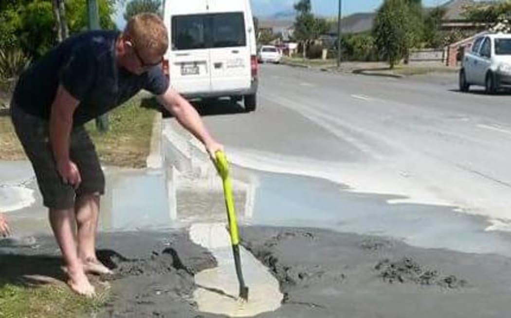 A man checks out the liquefaction following Christchurch's 5.7 magnitude quake.