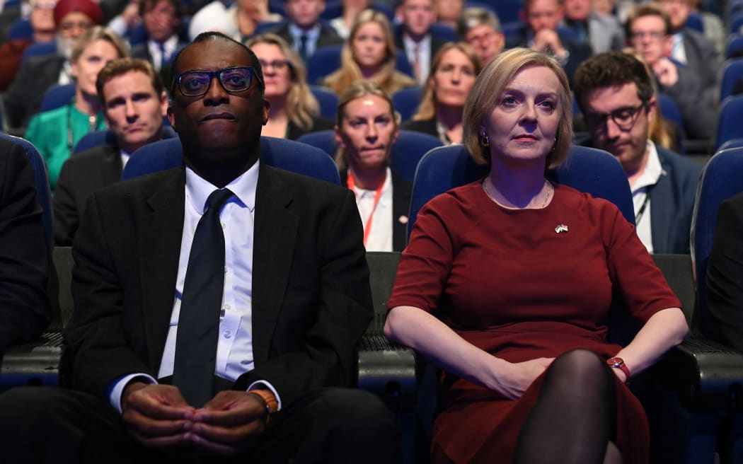 (FILES) In this file photo taken on October 2, 2022 Britain's Chancellor of the Exchequer Kwasi Kwarteng (L) and Britain's Prime Minister Liz Truss (R) attend the opening day of the annual Conservative Party Conference in Birmingham, central England. - Kwarteng has been sacked, the BBC and Sky News reported on October 14, 2022 quoting unnamed sources, as Truss tries to save her beleaguered premiership. (Photo by Oli SCARFF / AFP)