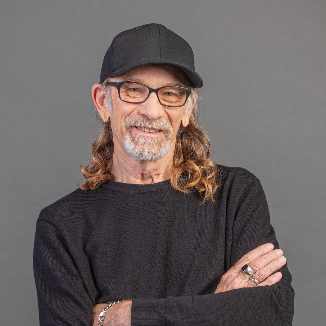 Trevor Reekie smiling wearing a black cap