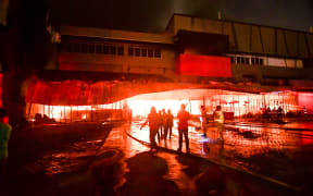 Firemen try to put out a fire inside a mall following a 6.4-magnitude quake in General Santos City, in southern island of Mindanao.