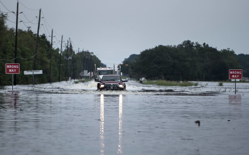 Trucks make their way through flood waters in Texas.