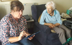 volunteer Robyn Grant helping Kerikeri Retirement Village resident Judith Donald (right) to get to grips with the online census process.