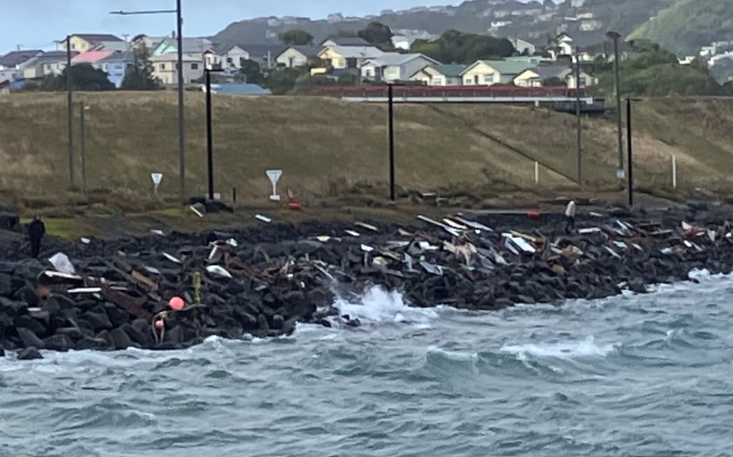 A scattering of debris is all that remains of a boat that was washed onto rock in high winds in Wellington's Evans Bay last night.