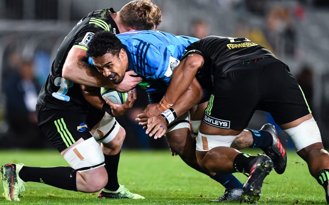 Blues player Jerome Kaino charges into the defence during a match against the Hurricanes.