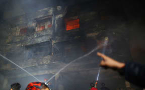 Fire-fighters try to control fire at Chawkbazar, old part of Dhaka city, Bangladesh on February 21, 2019.