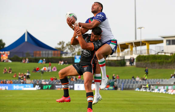 David Nofoaluma and Marcelo Montoya contest for the ball in the air.