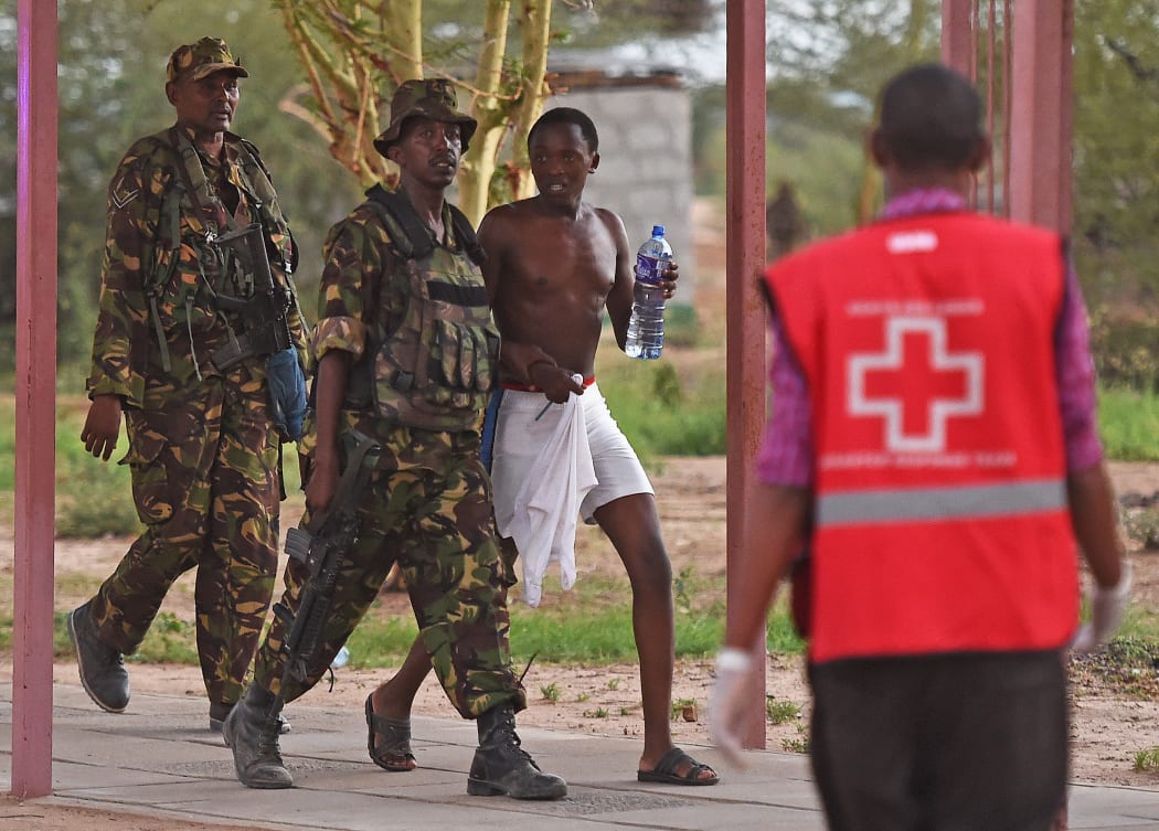 A male student hostage is escorted out of Garissa University.