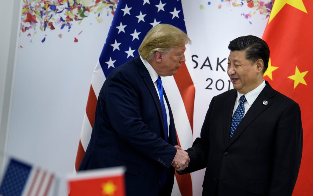 China's President Xi Jinping (R) greets US President Donald Trump before a bilateral meeting on the sidelines of the G20 Summit in Osaka on June 29, 2019.
