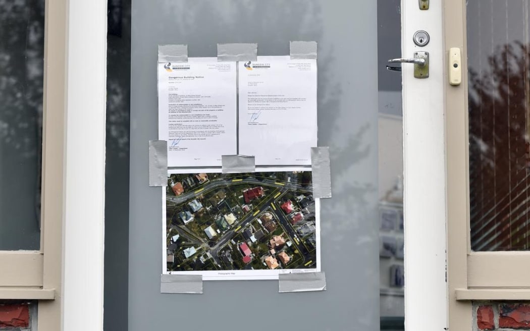A notice on the door of a house in St Clair evacuated because of a landslip