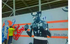 An artist keeps alive the memory of Johnny Aba with this artwork at the Sir Hubert Murray Stadium gate walls in Port Moresby in 2019.