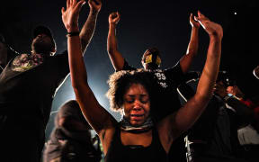 Demonstrators gather for staging a protest after an Atlanta police officer shot and killed Rayshard Brooks, 27, at a Wendy's fast food restaurant drive-thru Friday night in Atlanta, United States on June 14, 2020.